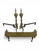 A pair of 19th century brass and iron firedogs together with a Georgian brass footman or trivet