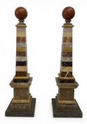 A pair of obelisks with spherical finials in specimen marble. H.43 W.11 D.11cm