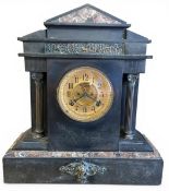An early 20th century French slate mantle clock with pitched marble pediment over the figural frieze