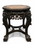 A small early 20th century Chinese hardwood plant stand or jardiniere with lobed marble top over the