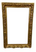 A large 19th century gilt gesso picture frame with allover scrolling foliate decoration. H.154 W.