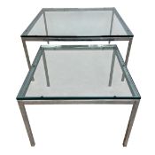 A pair of vintage coffee or side tables with thick square plate glass tops raised on polished chrome