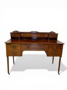 An Edwardian mahogany and satinwood inlaid writing desk with superstructural drawers over frieze and
