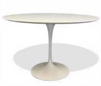 A contemporary Tulip dining table with white lacquered circular top over the painted metal base in