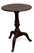 A 19th century mahogany lamp or occasional table with circular top over the turned pedestal raised