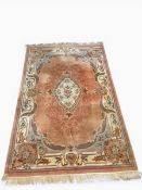 A large Chinese style Kayam carpet with central floral medallion in a scrolling foliate field over