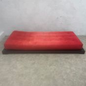 A contemporary 'Futura' daybed or chaise longue with red canvas upholstered adjustable mattress