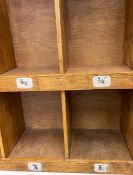 An early to mid 20th century pine shoe rack with slatted top over ten recesses over two tiers raised