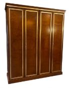 A large contemporary Empire style four door lacquered burr elm wardrobe with moulded cornice over