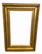A large 19th century egg-and-dart moulded, carved giltwood picture frame. H.142 W.96cm