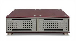 A contemporary coffee table having a red glass top over two recesses with removable magnetic