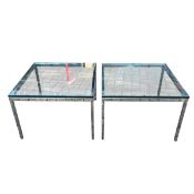 A pair of coffee or side tables with thick square plate glass tops raised on polished chrome