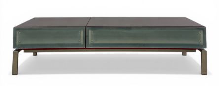 A contemporary coffee table having a modular top with sliding and rotating action over two frosted