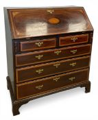 A Georgian marquetry inlaid mahogany bureau with fall-front enclosing a fitted interior over two