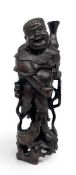 A C.1900 Chinese carved hardwood and white metal inlaid Liu Haichan figure group with glass eyes