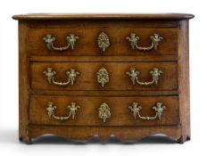 An 18th century French chestnut commode chest C.1750 having a pleated top and three long bow-fronted