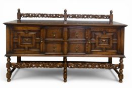 A mid century Jacobean style oak buffet or sideboard with carved openwork gallery back over an