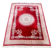 A large vintage Chinese style medallion area rug with floral medallion over the box red ground