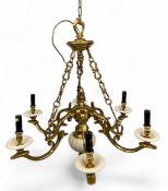 A vintage French Rococo style brass chandelier with six scrolling handles terminating in circular