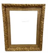 A 19th century gilt gesso picture frame with woven latticework border in a scrolling foliate