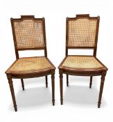 A pair of French Louis XVI style mahogany side or accent chairs each with a shaped, brass mounted