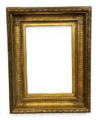 A 19th century husk and swag moulded French Empire style gilded scotia frame with fluted profile and