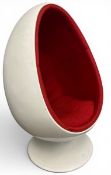 A mid century retro white plastic egg pod chair with red calico upholstered interior and rotating