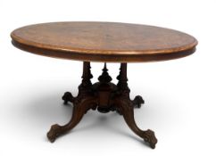 A mid 19th century burr walnut tilt-top dining table with satinwood Arabesque style inlay on well