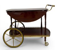 A 1970's vintage two tier drinks trolley with drop flaps and brass gallery and wagon wheels. H.69