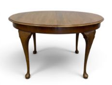 A vintage mahogany extending dining table with oval thumb-moulded top raised on shaped cabriole