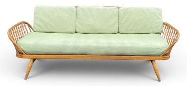 A mid century Ercol Studio Couch, beech and blonde elm, model 355. H.81 W.203 D.77cm (Some wear to