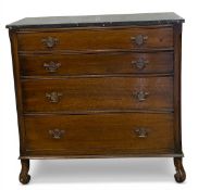 A 19th century oak chest with black marble top over four long graduating drawers raised on carved