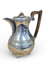 An English hallmarked silver hot water jug, Chester 1934. H.23cm. Weight 731g.