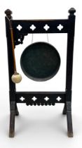 A 19th century oak gong on stand in the Arts and Crafts style. H.94 W.50 D.34cm