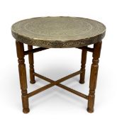 A vintage Middle Eastern brass tray top coffee table in two parts with engraved and inscribed