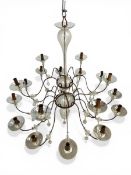 A large late 19th century eighteen branch wrought iron chandelier with two tiers of scrolling