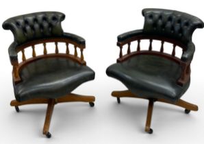A pair of 19th century style leather upholstered captain's chairs with tilt and swivel action. H.