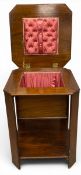 A mid century Art Deco style walnut and crossbanded work table with lift up top revealing a fitted
