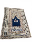 A large Anatolian Ghiordes prayer rug with central mihrab in a foliate field over an abrash ground