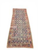 A Persian Ziegler carpet or runner with allover polychrome foliate field over a midnight blue ground