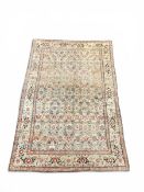 A Turkish area carpet with scrolling foliate field over a beige abrash ground within a repeating