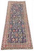 A large Persian Ziegler carpet or runner with allover polychrome foliate field over a midnight