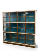 A contemporary Roche Bobois Architecte cabinet in three sections fitted with glass shelves and