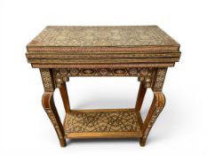 A late 20th century Syrian Damascus inlaid games table with hinged swivel top enclosing backgammon