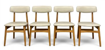 A set of four mid-century style Linsy dining chairs each with a cream leatherette upholstered back