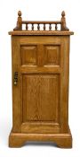A C.1900 limed ash bedside pot cupboard or side cabinet with spindled gallery top over the