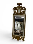 A Gustavian Stockholm pier mirror with carved and gilt feather and ribbon cresting over the vacant