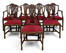 A set of eight Hepplewhite style mahogany shield-back dining chairs each with a carved openwork