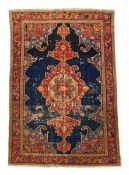 An Afghan Serapi carpet with central pole medallion over a midnight blue abrash ground within