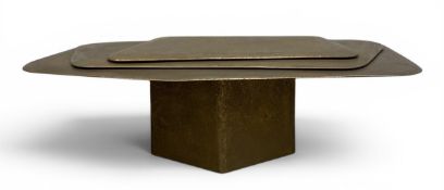 A contemporary bronzed composite resin Calanque style coffee table with layered pebble top raised on